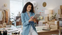 Business woman using a tablet in a small business logistics centre