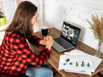 Woman attending an online meeting from home